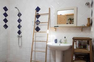 a bathroom with a white sink and a ladder at Casa Milita in Tavira +15 photos