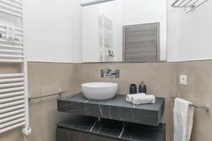 a bathroom with a sink and a mirror at Rifla Vacanze in La Maddalena +18 photos