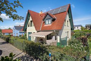 a house with solar panels on its roof at Ferienbungalows Werner in Koserow
