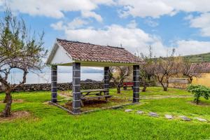 a gazebo with a picnic table in a park at Casa da Praya in Horta