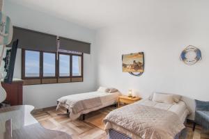 a bedroom with two beds and a window at Vv Suite Las Velas in Gáldar