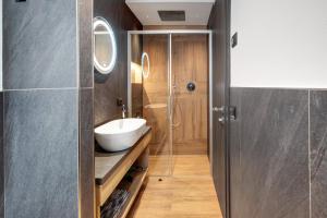 a bathroom with a sink and a glass shower at Chalet Kb in Livigno +39 photos