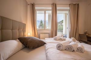a hotel room with two beds with towels on them at Residence La Villa Tesoro in Tignale