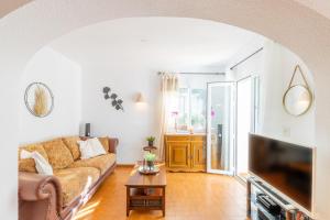 a living room with a couch and a tv at Casa Sillero Dos in Moraira