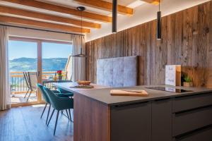 a kitchen with a counter and a table with a view at Moarhof Ums in Umes