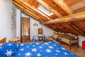 a bedroom with a bed and a wooden ceiling at Casa da Praia 1 in Budens