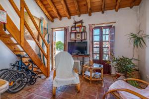 a living room with a bicycle and a staircase at Casa da Praia 1 in Budens