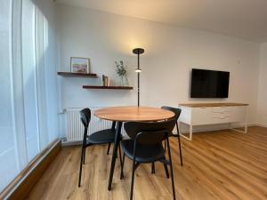 a dining room with a table and chairs and a television at Myzell in Radolfzell am Bodensee