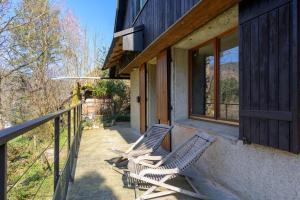 two chairs sitting on the porch of a house at Chalet in Mittlach