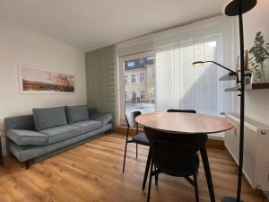 a living room with a couch and a table at Myzell in Radolfzell am Bodensee