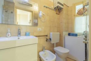a bathroom with a toilet and a sink and a mirror at La finestra sul mare in Ospedaletti +34 photos