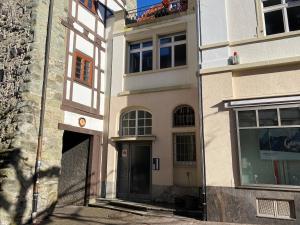 a building with a black door and a window at Myzell in Radolfzell am Bodensee