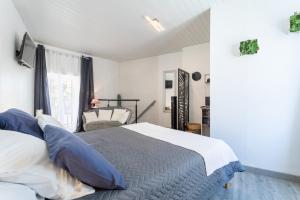 a bedroom with a bed with blue and white pillows at Logis Du Roussillon in Bélesta