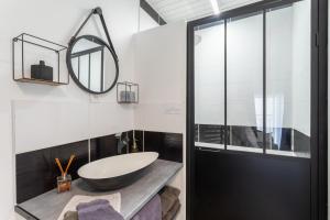 a bathroom with a sink and a mirror at Logis Du Roussillon in Bélesta +14 photos