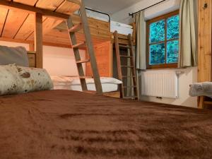 a bedroom with two bunk beds and a window at Bergchalet Zirbenzapfen in Judenburg