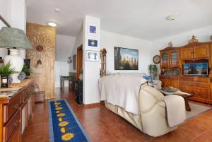 a bedroom with a bed and a couch and a table at Casa Lancelot in Tinajo