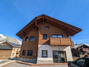 a house with a balcony on top of it at Chalet Kb in Livigno