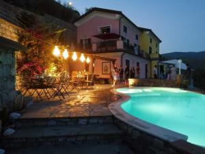 a swimming pool in front of a house at Villa Lice - Coronata in Casarza Ligure