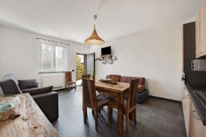 a living room with a table and a couch at Villa Lice - Coronata in Casarza Ligure
