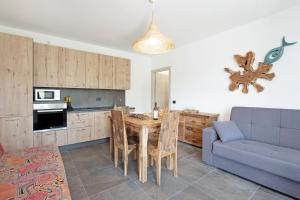 a kitchen and dining room with a table and a couch at Villa Lice - Coronata in Casarza Ligure