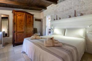 a bedroom with a bed with towels on it at Trullo Cielo Cielo in Alberobello +24 photos
