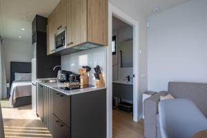 a kitchen with a sink and a stove in a room at Complejo Bungalow con piscina in A Pobra do Caramiñal