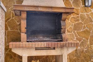 a stone pizza oven in a stone wall at Villa Pintor in Port de Pollensa