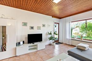 a living room with white walls and a flat screen tv at Ferienwohnung Wanderbar in Kamp-Bornhofen