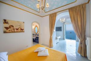 a bedroom with a bed with two towels on it at Luxury Villa Soleluna con jacuzzi in Praiano +23 photos