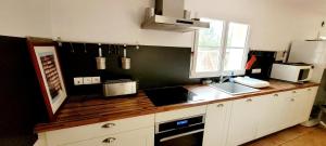 a kitchen with a counter with a sink and a window at La Maison Des Conches - Ref 803 in Longeville-sur-Mer