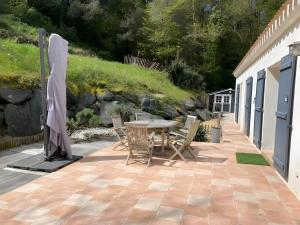 a patio with a table and chairs next to a building at La Maison Des Conches - Ref 803 in Longeville-sur-Mer