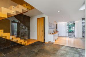 a living room with a staircase in a house at Tróia Villa Paradise in Troia