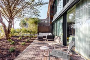 a patio with a table and chairs on a building at Tróia Villa Paradise in Troia