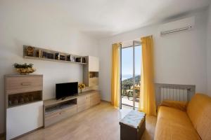 a living room with a couch and a television at I Girasoli in Alassio