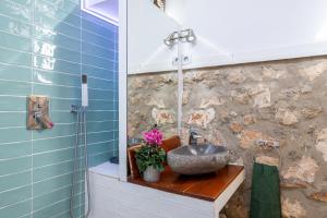a bathroom with a sink on a wooden counter at Apto Rural La Buganvilla in Valdelaguna +22 photos