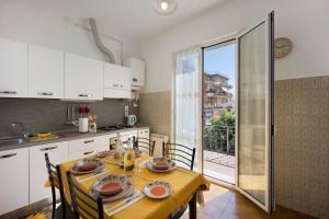 a kitchen and dining room with a table and chairs at I Girasoli in Alassio