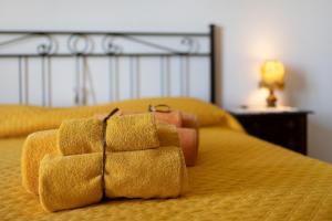 a yellow bed with a purse on top of it at I Girasoli in Alassio
