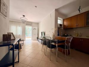 a kitchen with a table and chairs in a room at Casa d'Angelo by Horizon Homes in Orfánion