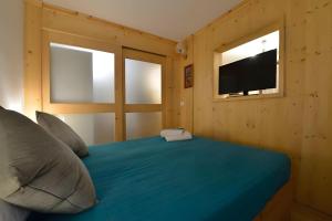 a bedroom with a bed with a television in it at Petit Bijou Morgex in Morgex