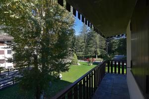 a balcony of a house with a tree on it at Petit Bijou Morgex in Morgex