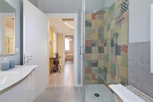 a bathroom with a glass shower and a sink at Maison Emozioni Terrace in Limbiate +26 photos