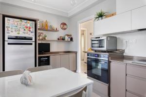 a kitchen with a refrigerator and a microwave at Maison Emozioni Terrace in Limbiate