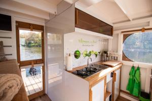 a kitchen with a sink and a stove in a trailer at Lisa Boot 3 in Priepert +2 photos