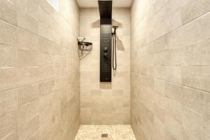 a bathroom with a shower with a shower head at Park Carpe Diem Studio in Busot +22 photos