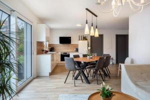a kitchen and dining room with a table and chairs at Ferienhaus Ebringen in Ebringen
