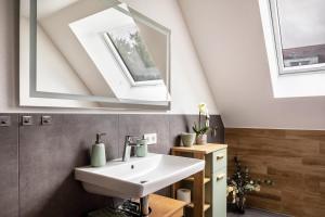 a bathroom with a sink and a skylight at Ferienhaus Ebringen in Ebringen +37 photos