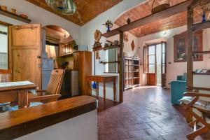 a kitchen with a table and a dining room at Nadine - Bilocale In Centro in Marciana +14 photos