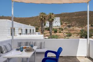 a table and chairs on a balcony with a view at Pico Bello Patmos 30 in Patmos