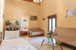 a living room with a couch and a table at Andros Traditional House in Andros +20 photos