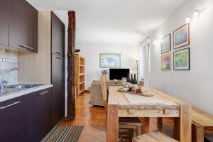 a kitchen and dining room with a wooden table at Maison Gnemaz Grand Combin in Aosta